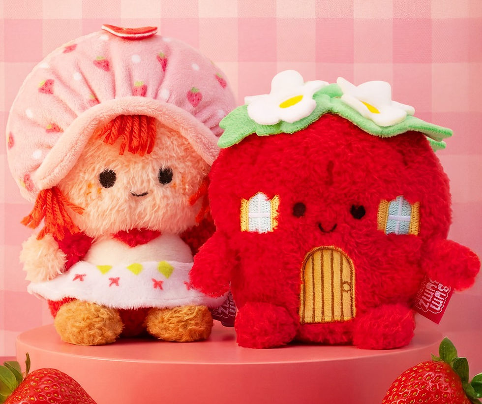 Girl and Strawberry House plush next to each other. 